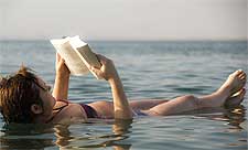Photo of woman reading a book in the Red Sea, by Patrik Neckman