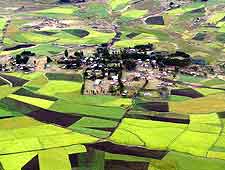 Aerial view, showing the lush patchwork of fields and plantations