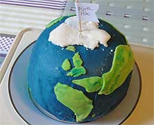 Photo of birthday cake in the shape of the world