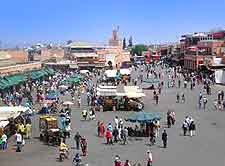 Photo of central Djemaa El Fna market and tourists