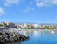 Coastal view of Sicily, showing Mount Etna in the distance