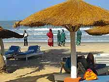 Photo of beachfront, showing thatched parasols