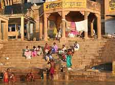 Photo of locals paying at a waterfront ghat