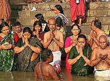 Close-up picture showing locals praying in the River Ganges