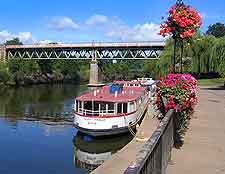 Riverside photo, showing the Severn lined with summer flowers